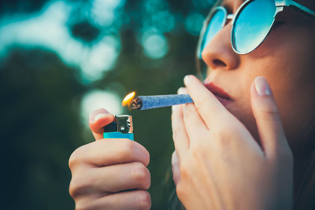 woman smoking blueberry preroll